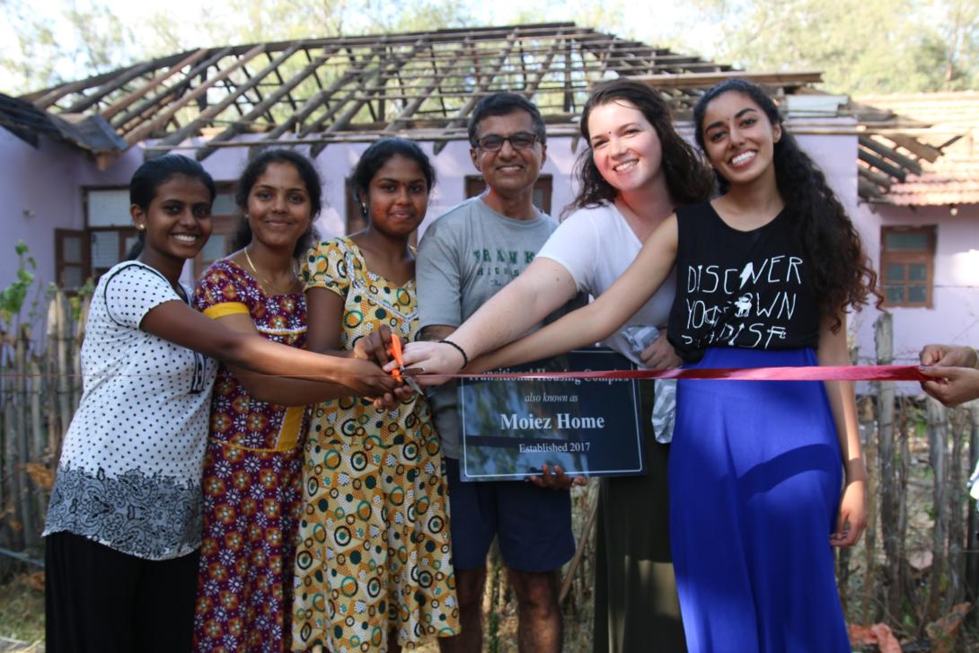 Two University of Michigan students pose with their community partners in Sri Lanka, as part of their Davis Project for Peace.
