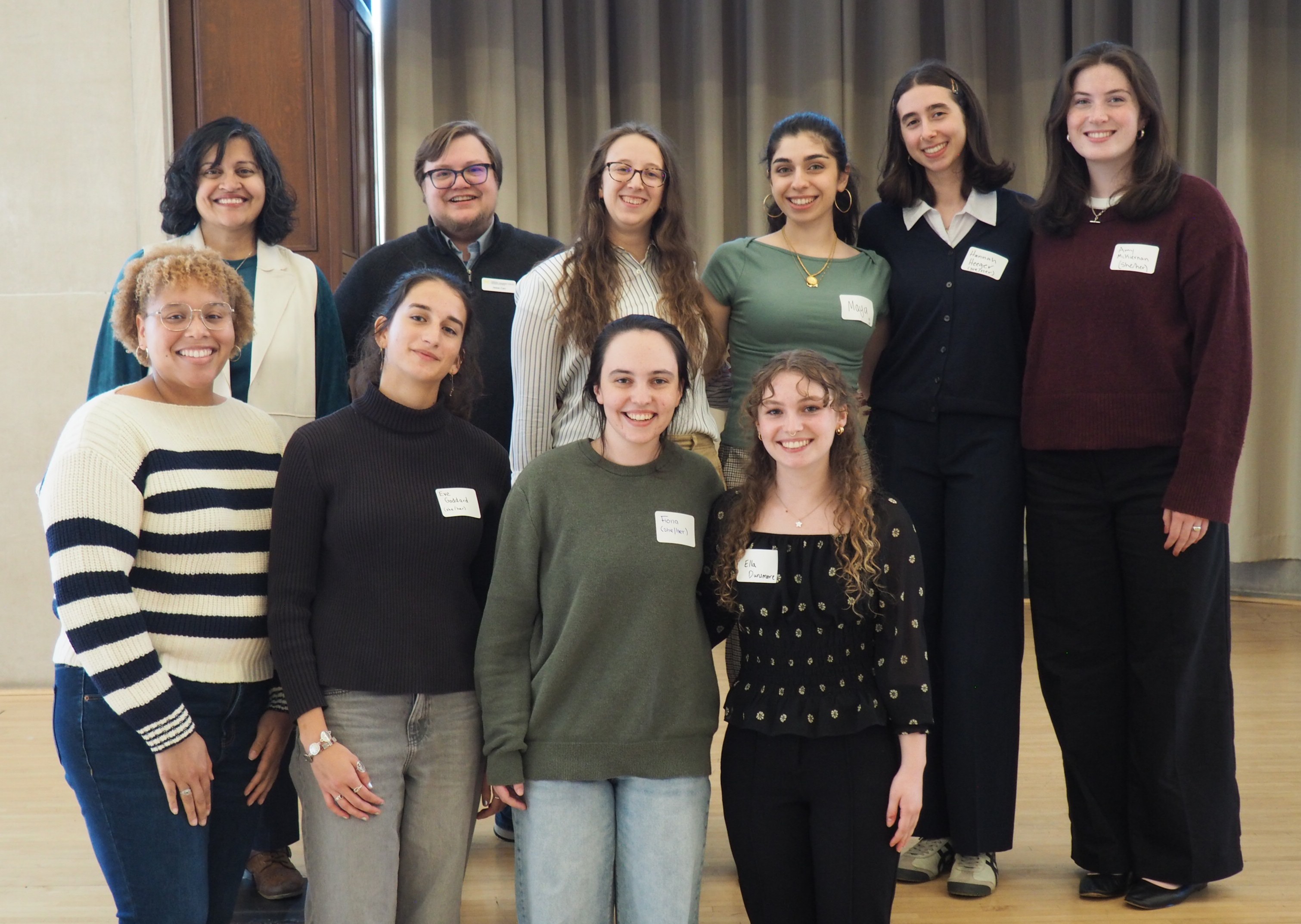 A group of undergraduate students standing in two rows with 2 U-M staff on top row