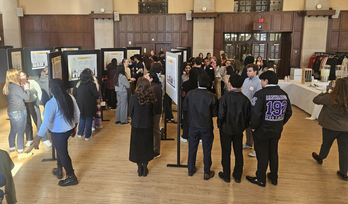 Students gathered around posters in the Michigan Union Ballroom