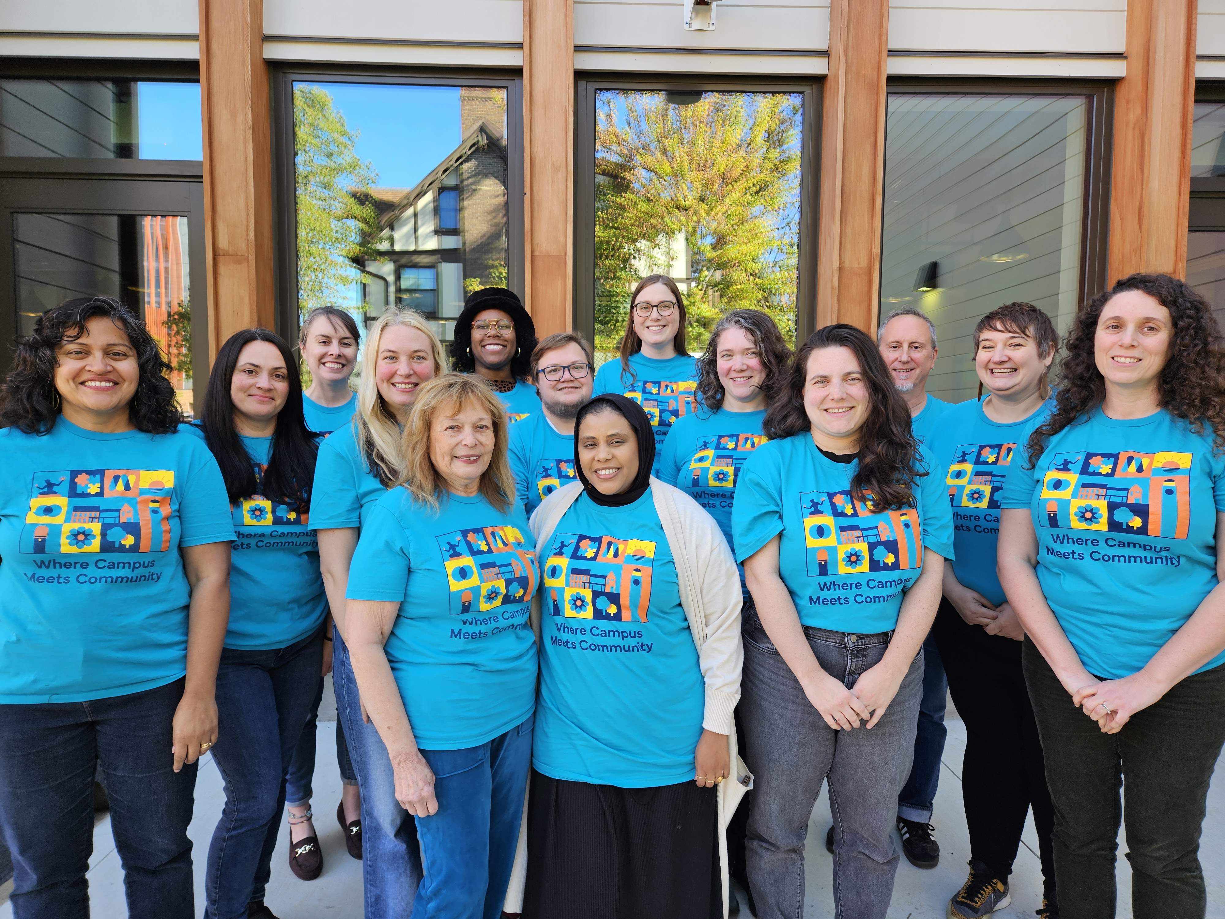 staff photo of Ginsberg Center employees in teal shirts
