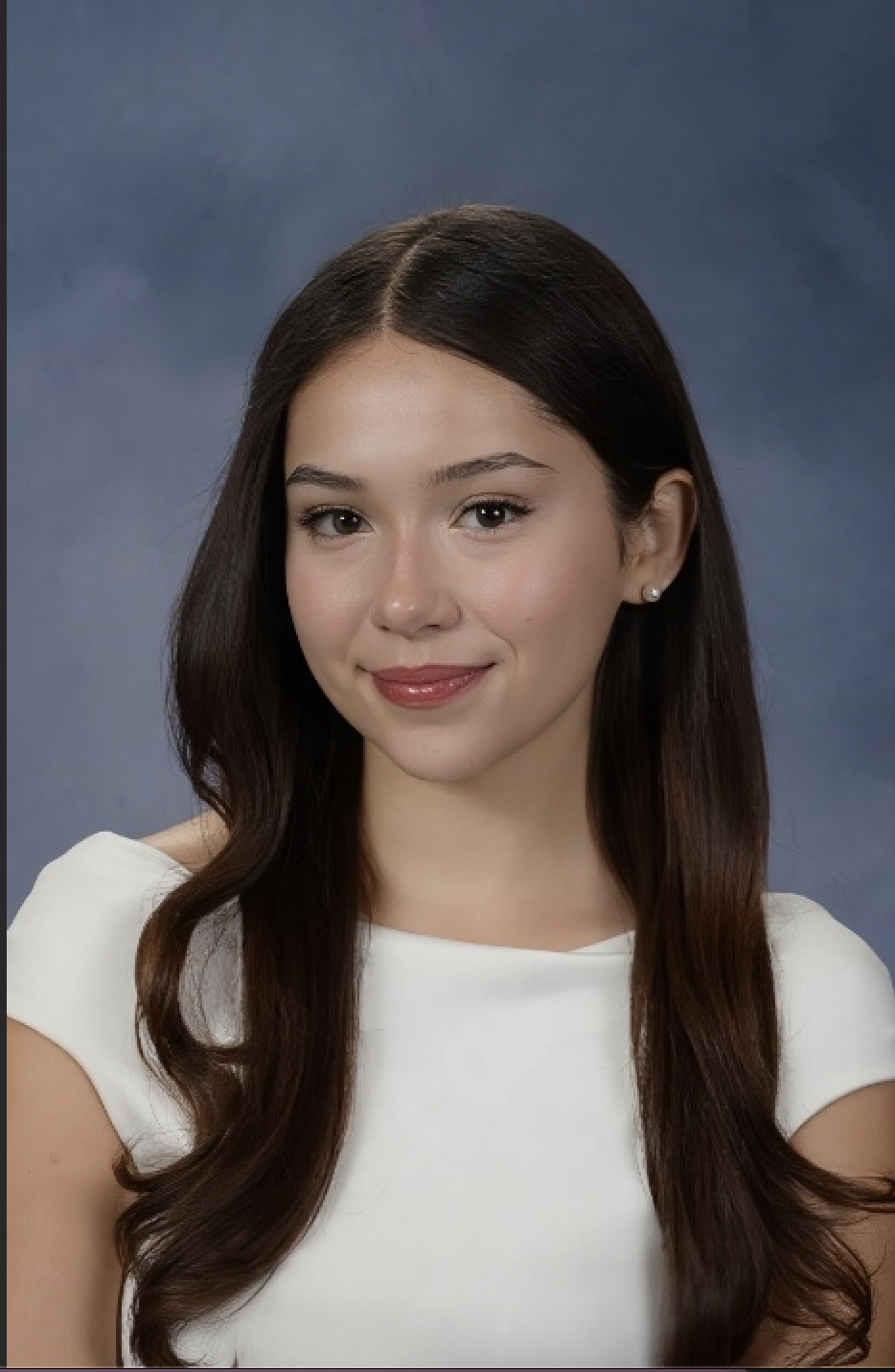 photo of a person with long dark hair smiling at the camera wearing a white shirt