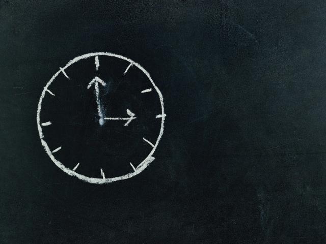 clock drawn on a chalkboard