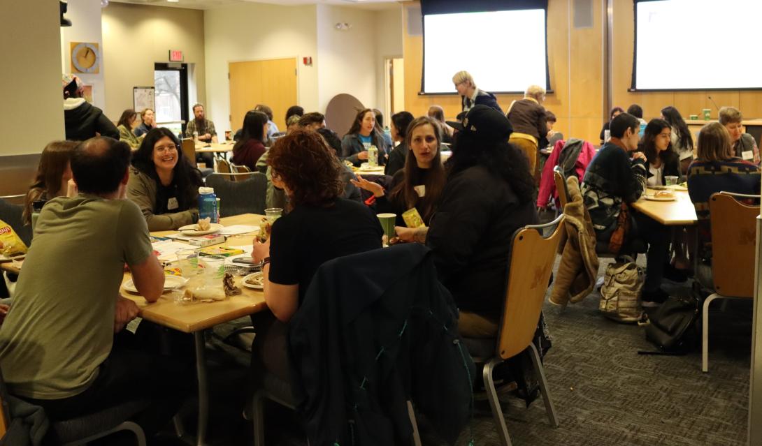groups of people sitting around table in an open room