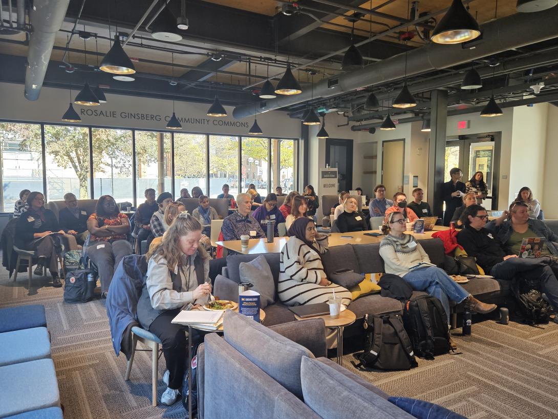 Group of people sitting on chairs and couch in the Ginsberg Community Commons
